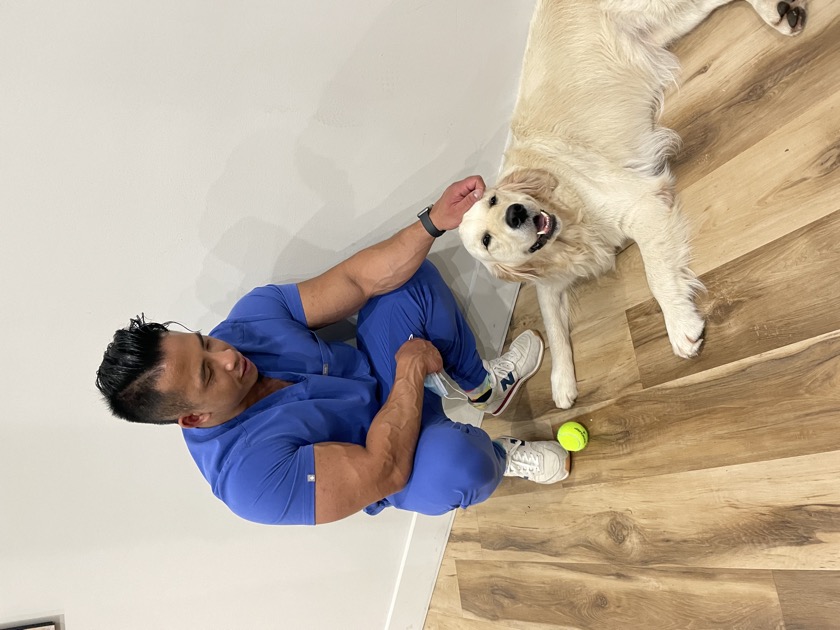 Dr. Johnny Nguyen, DC with his dog outside the studio